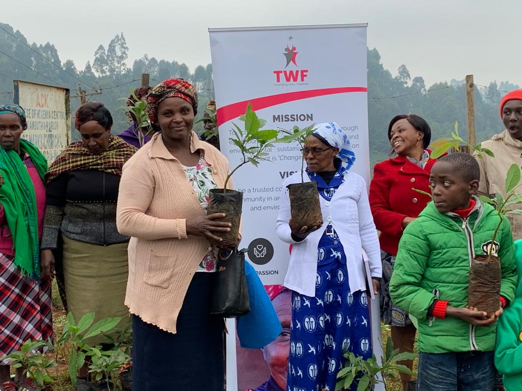 Community members receiving support and seedlings